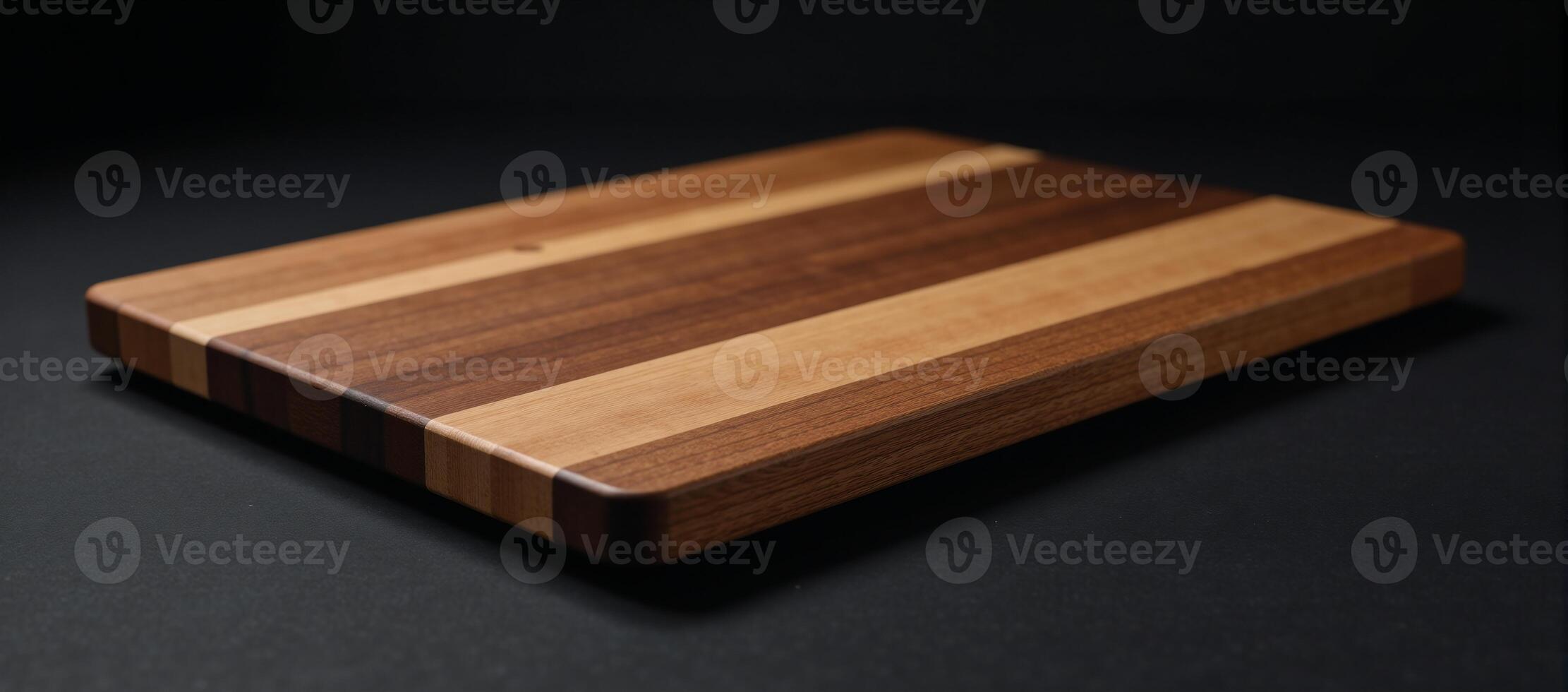 Wooden walnut cutting board against a dark backdrop photo