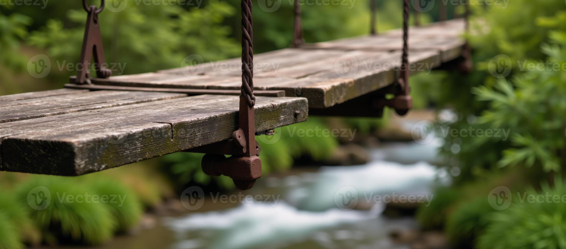 An old suspended wooden bridge against a scenic backdrop photo