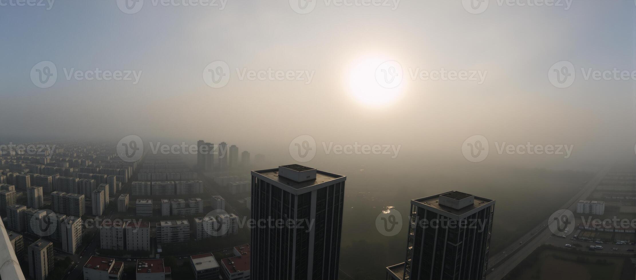 Cityscape panorama showcases the early morning sky over a foggy urban landscape photo