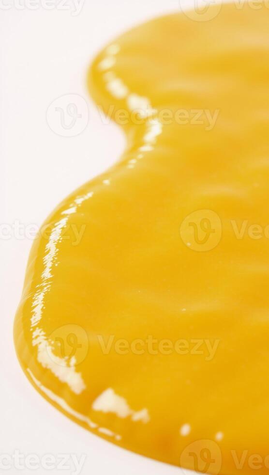 Melted cheese puddle with glossy texture against white backdrop YellowOrange Cheese photo