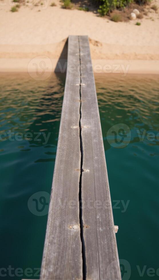 Abstract river scene water and natural elements depicted on an old wooden slab with a darkturquoise epoxy finish viewed from above over a sandy beach and riverbanks drone perspective photo