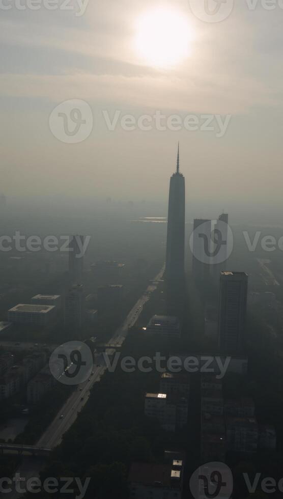 Cityscape panorama showcases the early morning sky over a foggy urban landscape photo