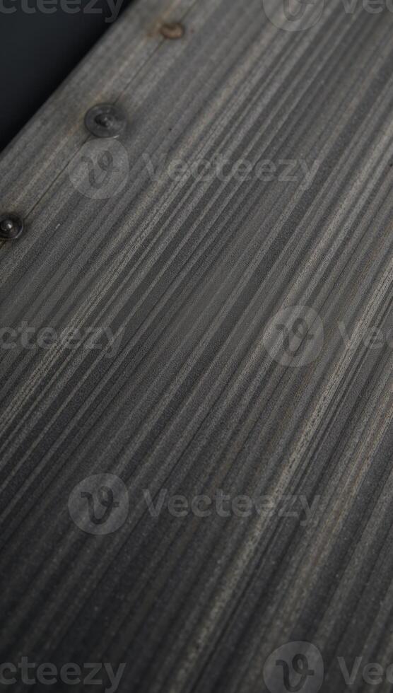 A worn textured gray chopping board with rustic appeal and noticeable scratches photo