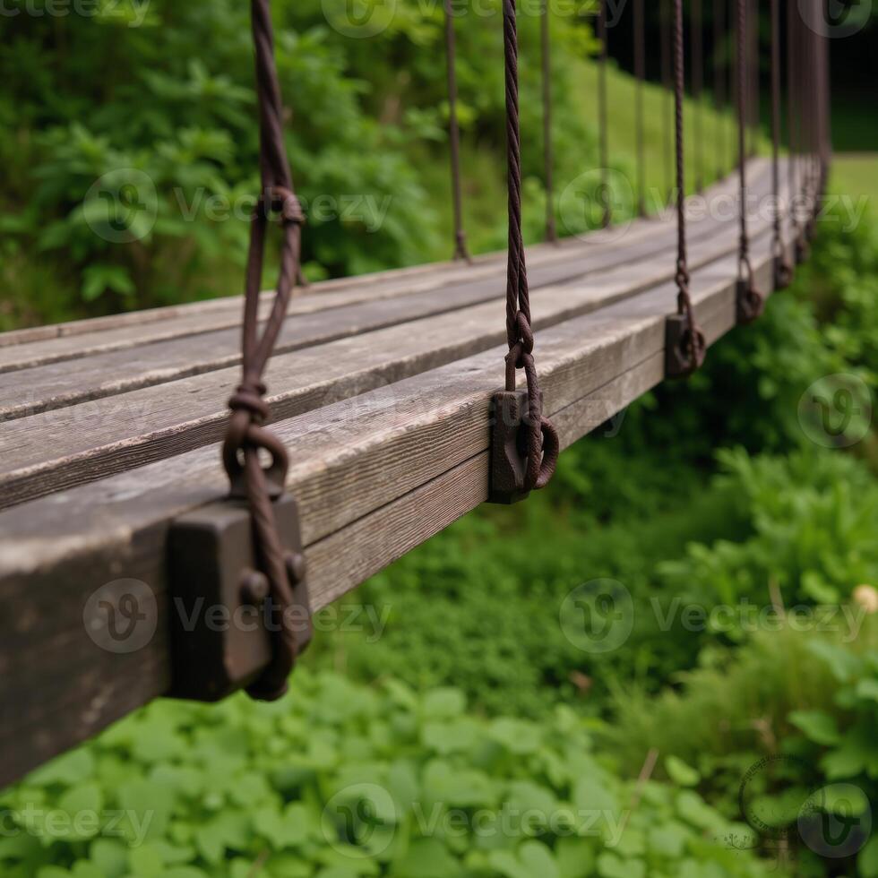 An old suspended wooden bridge against a scenic backdrop photo