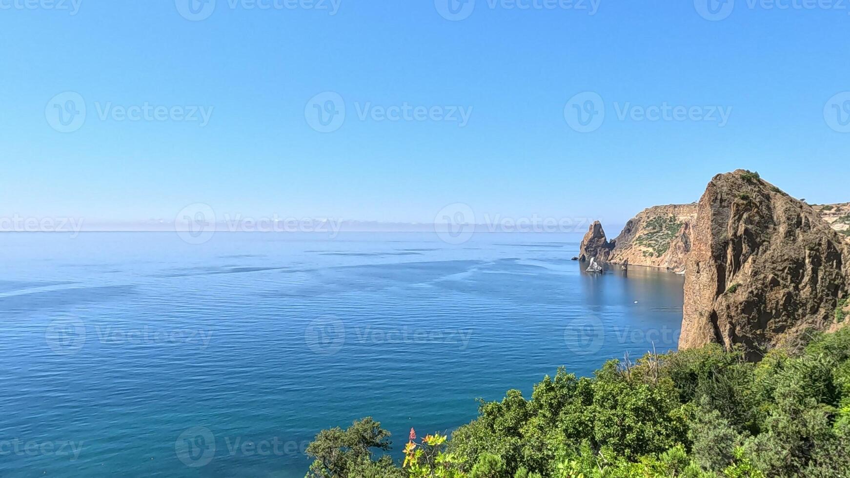 Aerial view on calm azure sea and volcanic rocky shores. Small waves on water surface in motion blur. Nature summer ocean sea beach background. Nobody. Holiday, vacation and travel concept photo