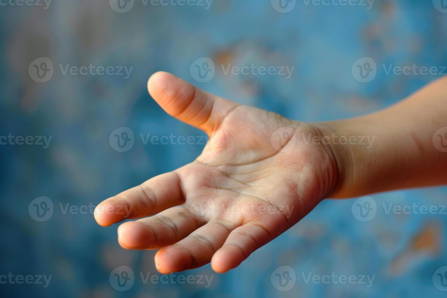 Child holding out empty hand asking for help photo