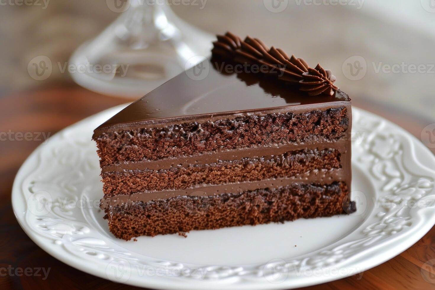 Slice of chocolate cake with chocolate frosting on white plate photo