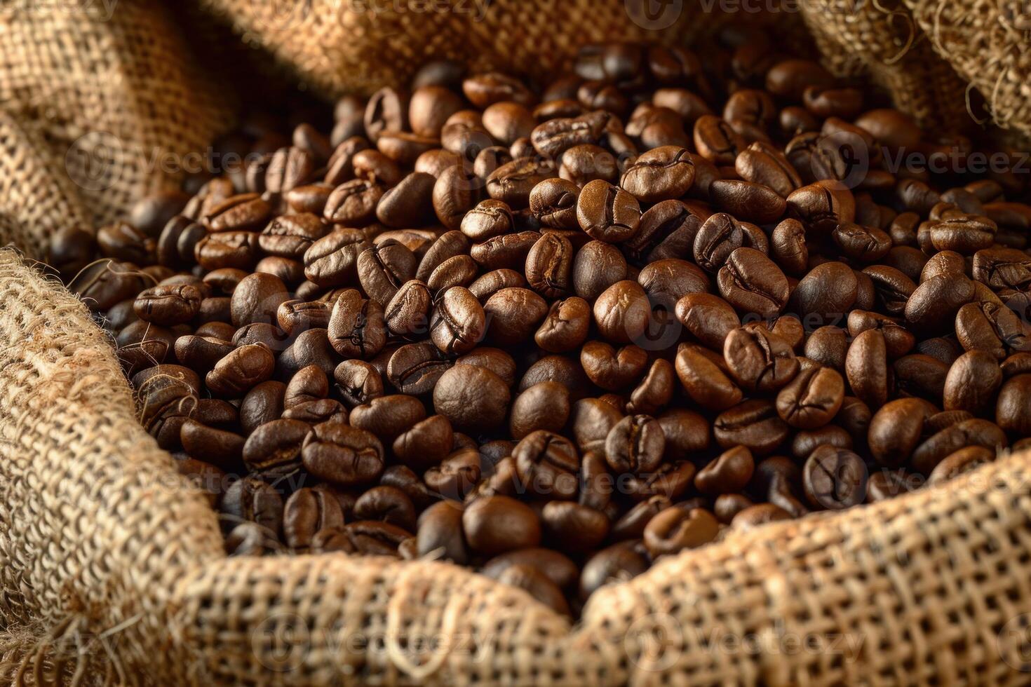 Roasted coffee beans overflowing from burlap sack photo