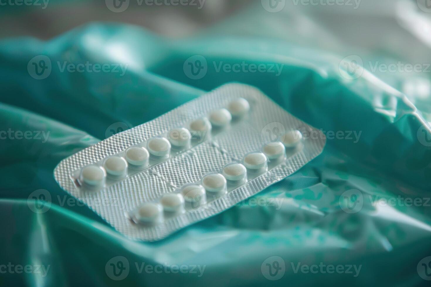 Contraceptive pill resting on a crumpled plastic wrap background photo