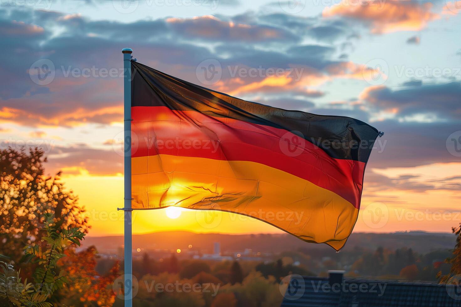 Large german flag waving in the wind at sunset photo
