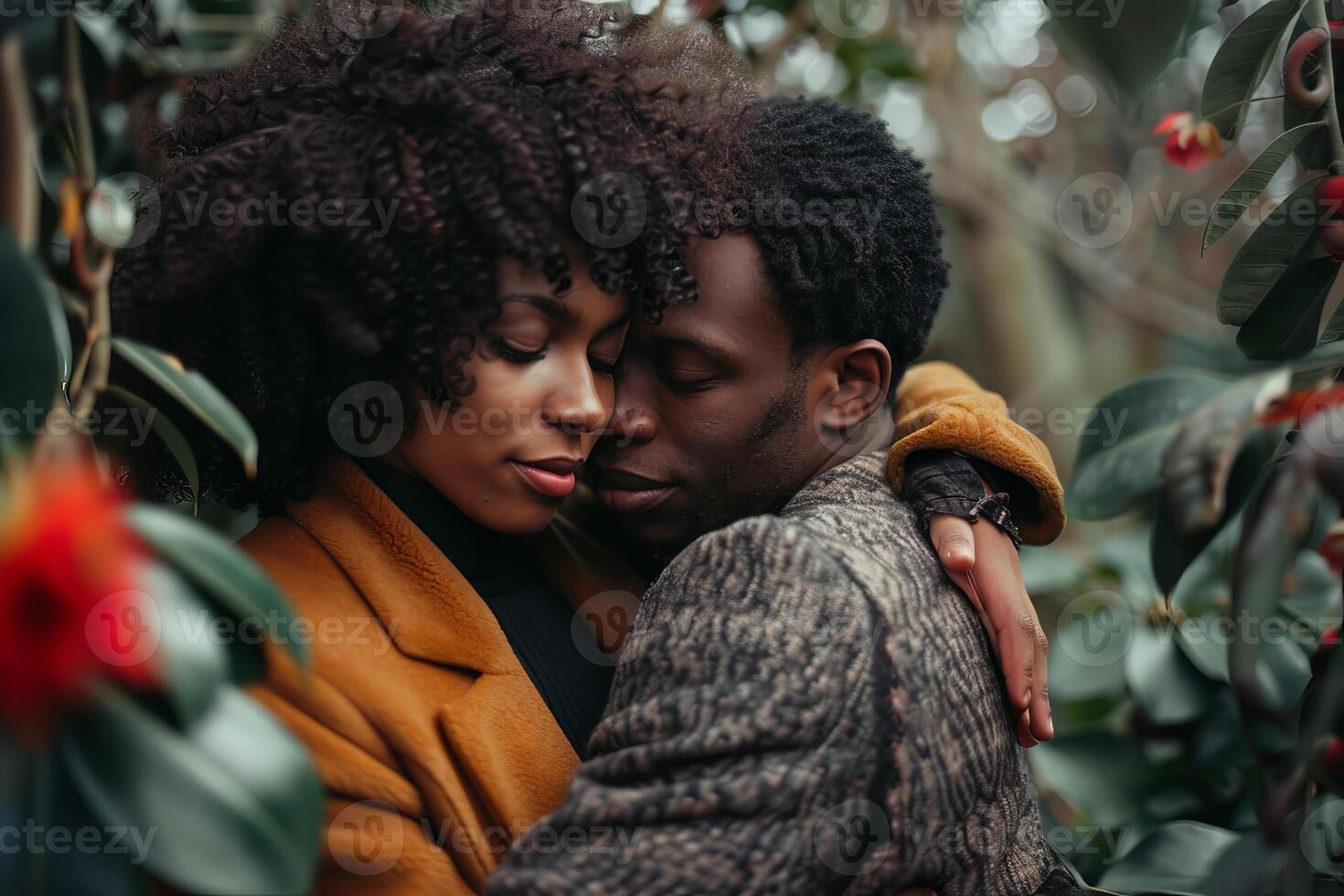 Young couple sharing tender moment hugging in lush garden photo