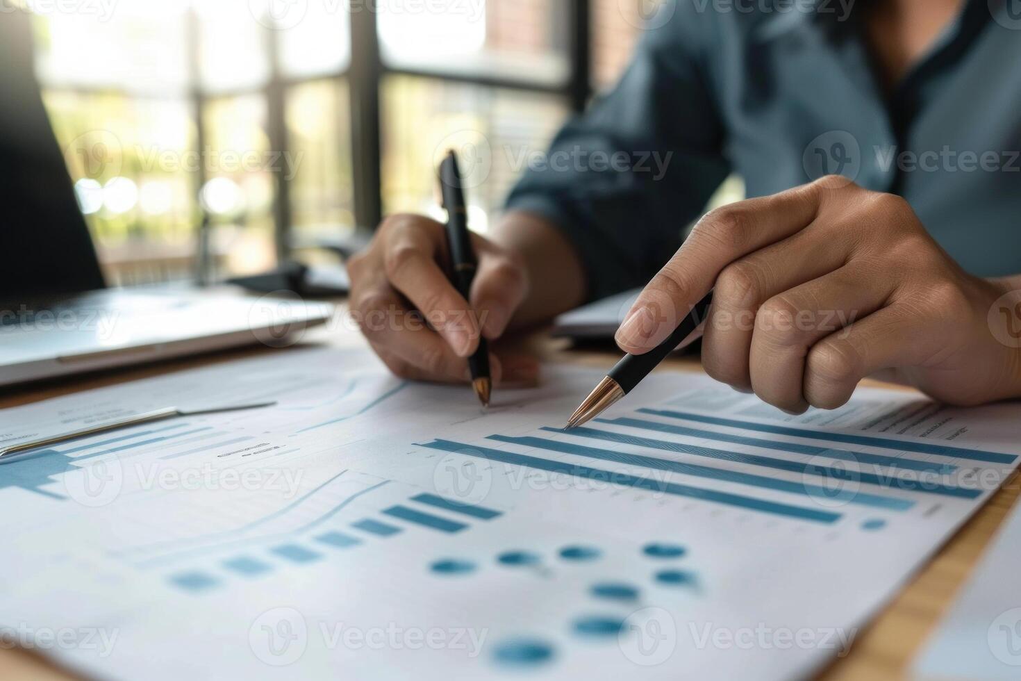 Close up of a female professional examining graphs and statistics on paper documents photo
