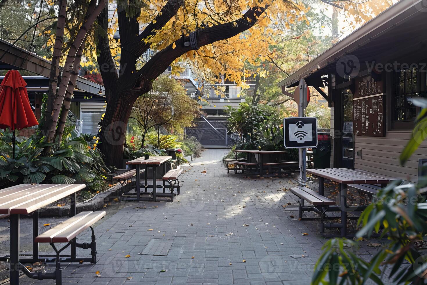 Empty outdoor cafe tables with free wifi sign in autumn photo