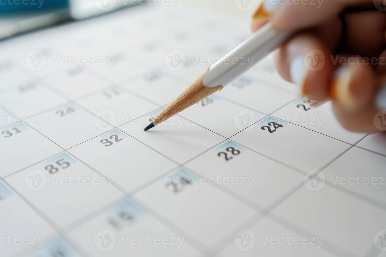 Close up of a calendar with a pencil marking a date photo