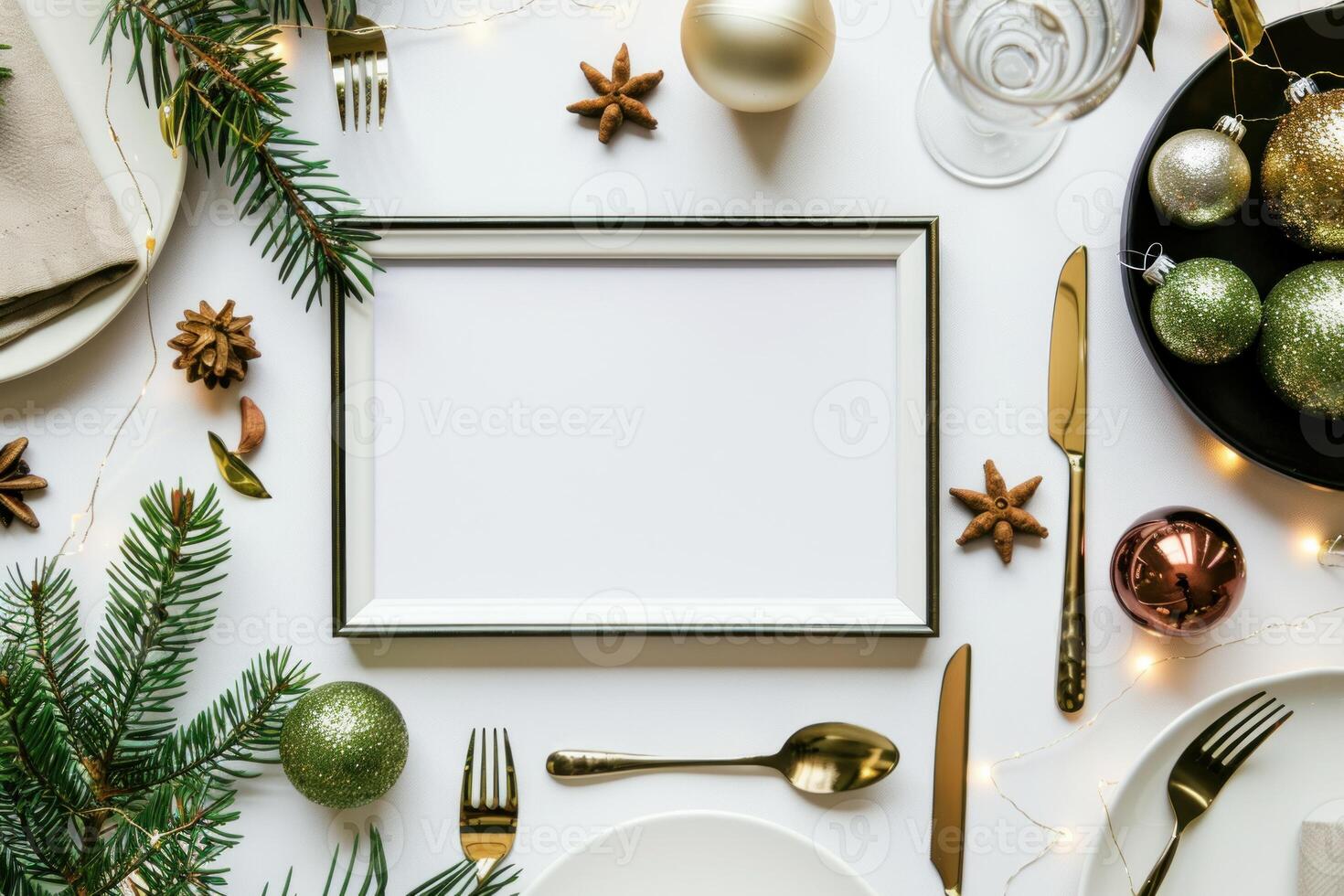 Christmas table setting with blank frame surrounded by fir branches and decorations photo