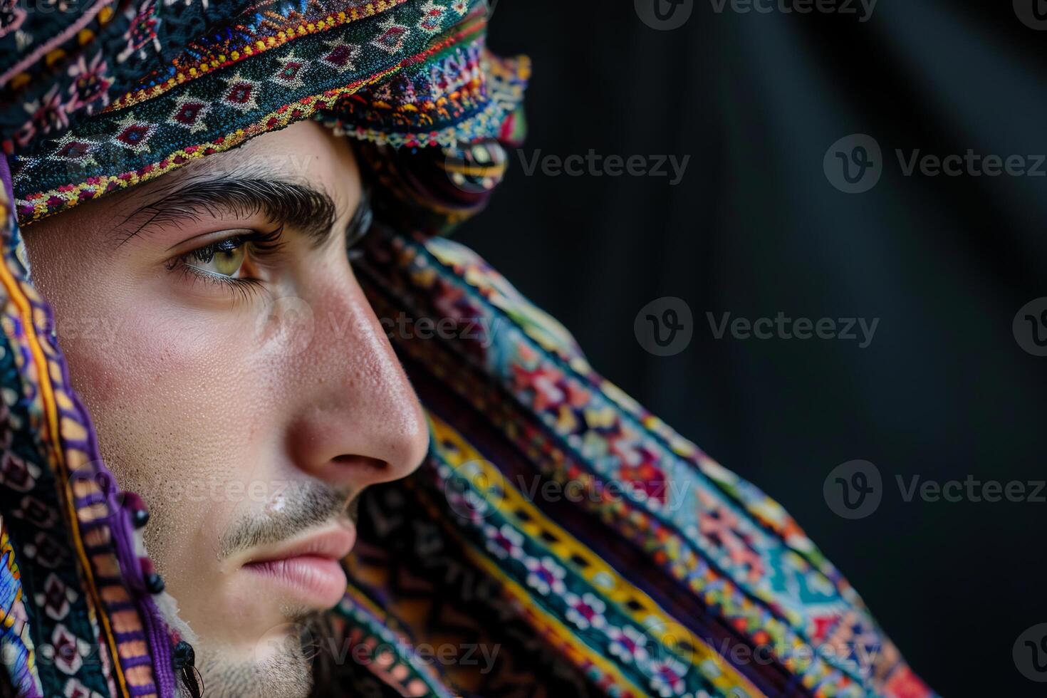 Young man wearing traditional keffiyeh looking to side with neutral expression photo