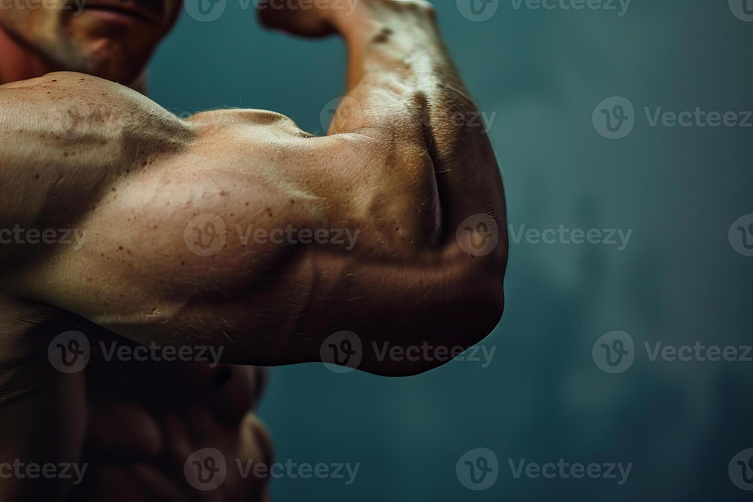 Bodybuilder posing and showing his biceps muscle photo