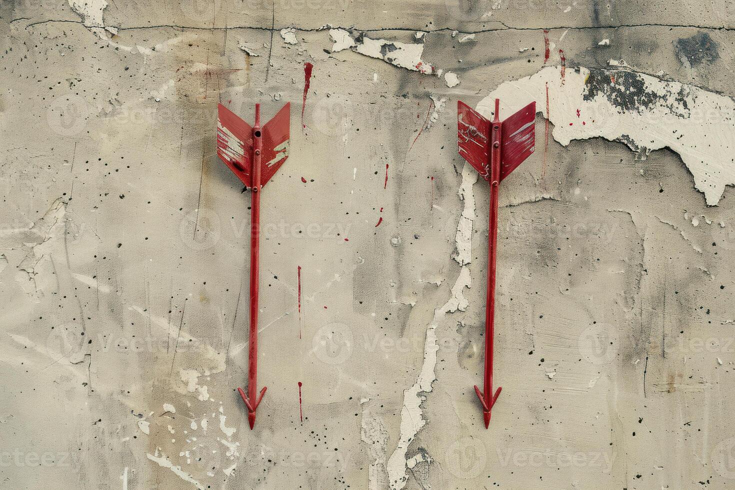 Two red arrows pointing down on a grunge concrete wall photo