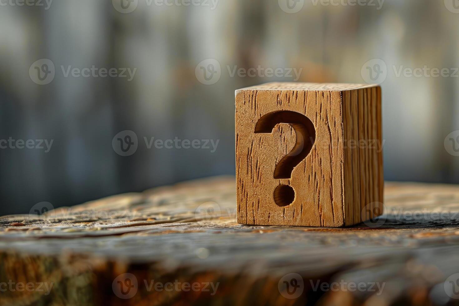 Wooden cube showing question mark on rustic wood surface photo