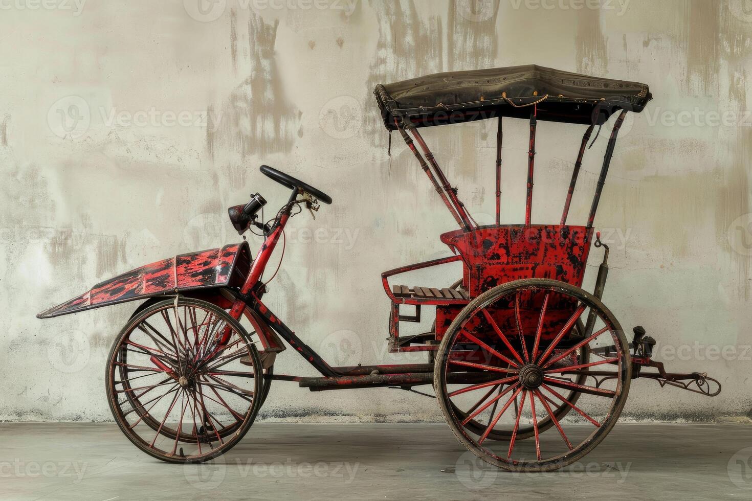 Antique red rickshaw with big wheels parked indoors photo