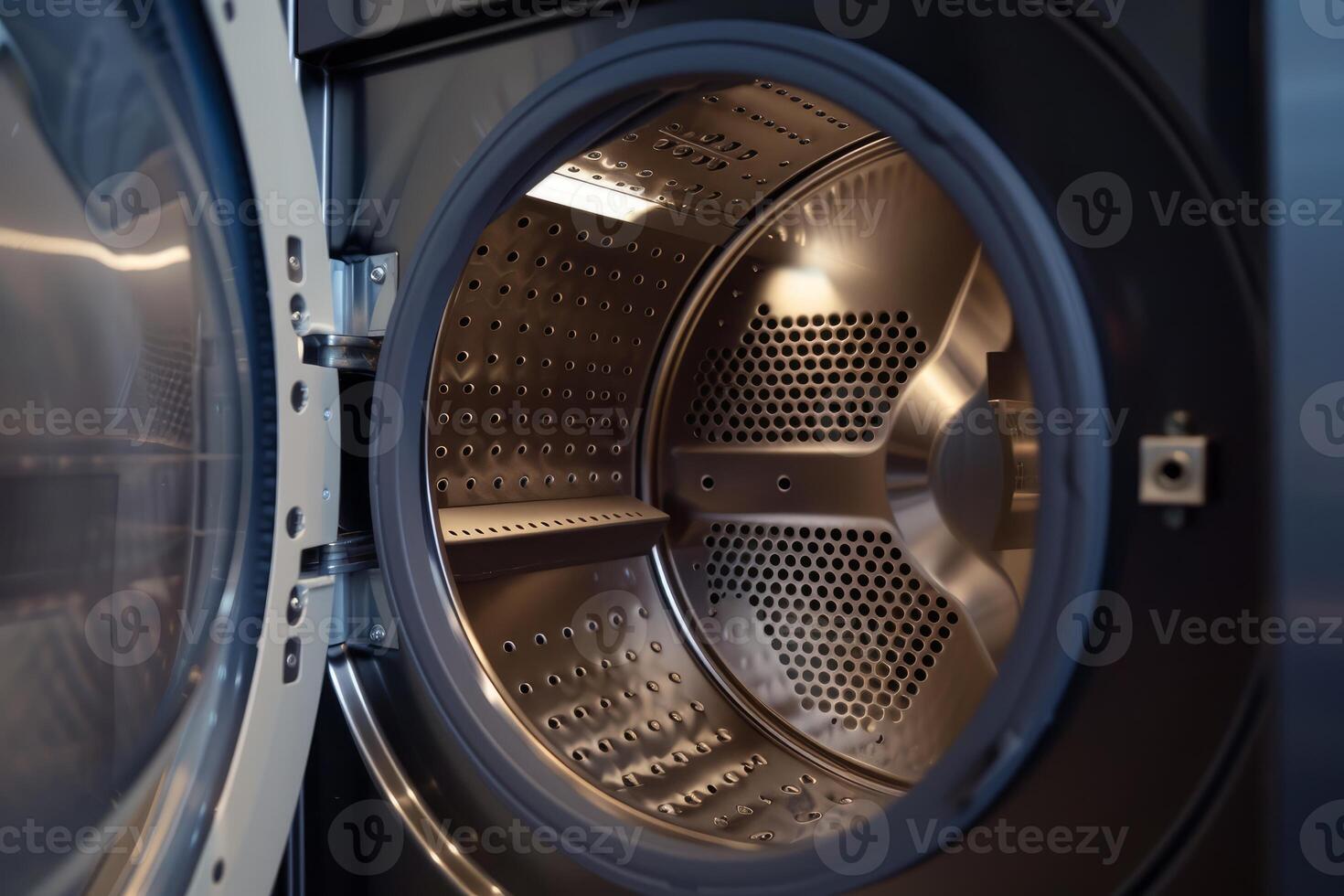 Open empty washing machine showing its stainless steel drum photo