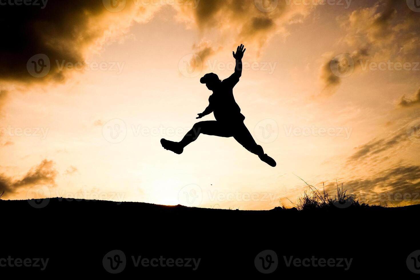 A man jumping in the air at sunset photo