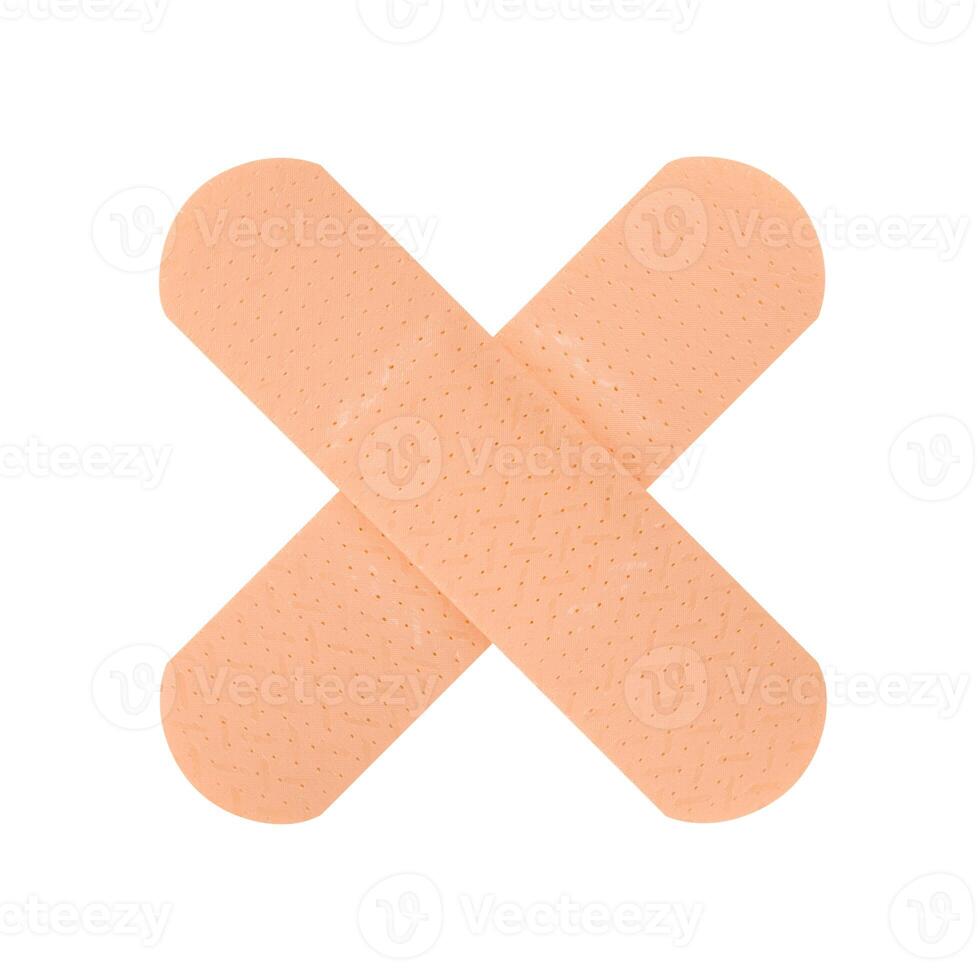 Two plasters in the shape of a cross isolated on a white background. Stock photo. photo