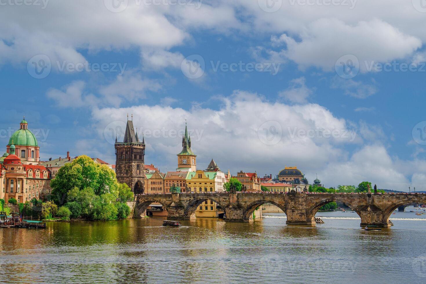 Beautiful cityscape image of Charles Bridge and Prague Castle with blue sky and white clouds in background, Czech Republic, Europe. Famous travel destination and touristic attraction of Czech Republic. photo