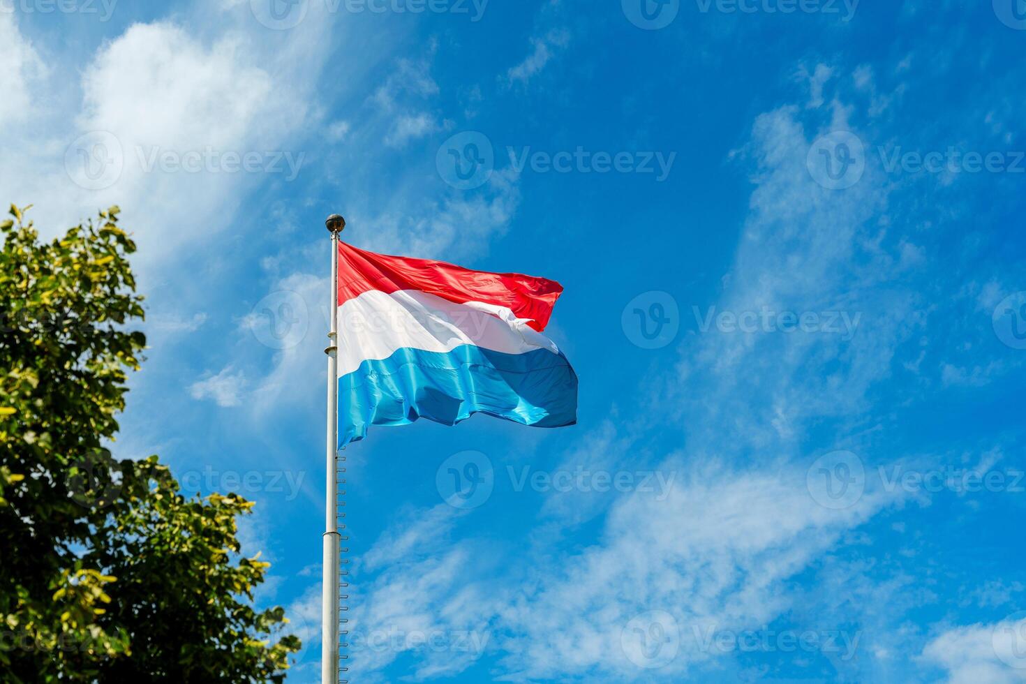 The Luxembourg flag features three vertical bands of blue, white, and red, symbolizing liberty, equality, and fraternity. Adopted in 1794, it represents the values of the French Revolution. photo