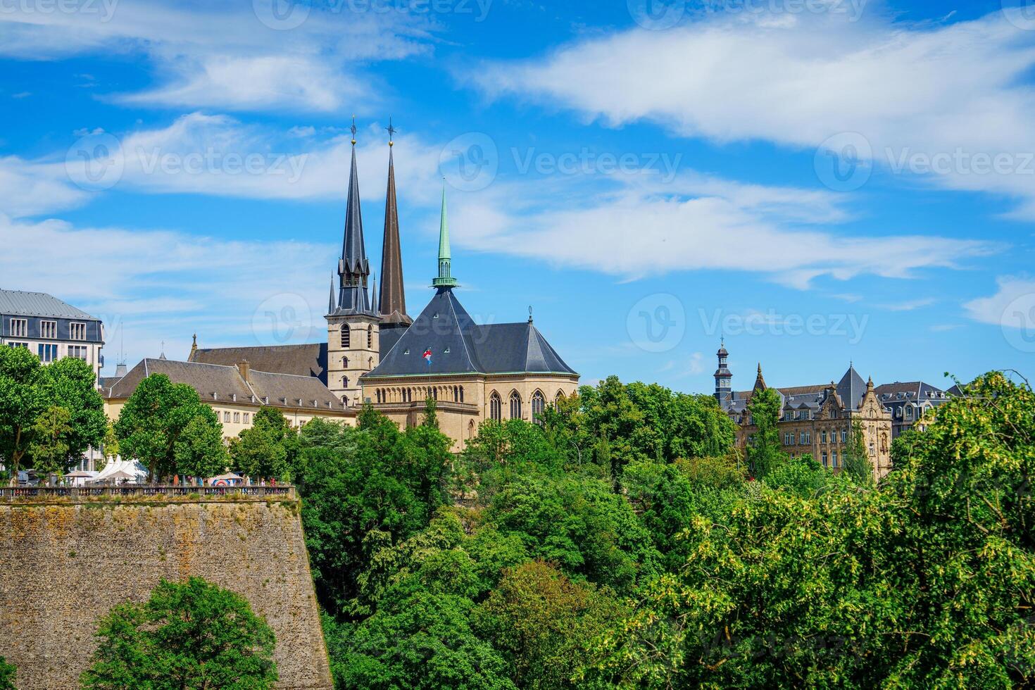 The image features Notre-Dame Cathedral and a section of the fortress wall in Luxembourg City. The Cathedral, completed in 1613, is the citys iconic landmark, offering stunning views and is a must-visit. photo