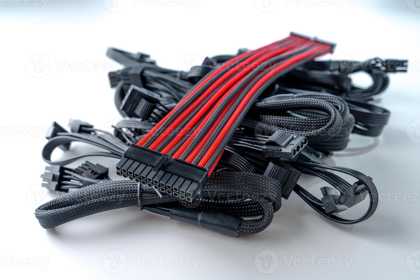 A black and red computer cable is isolated on a white background. This durable cable ensures efficient connections between computers and power sources, providing reliable performance for various devices. photo