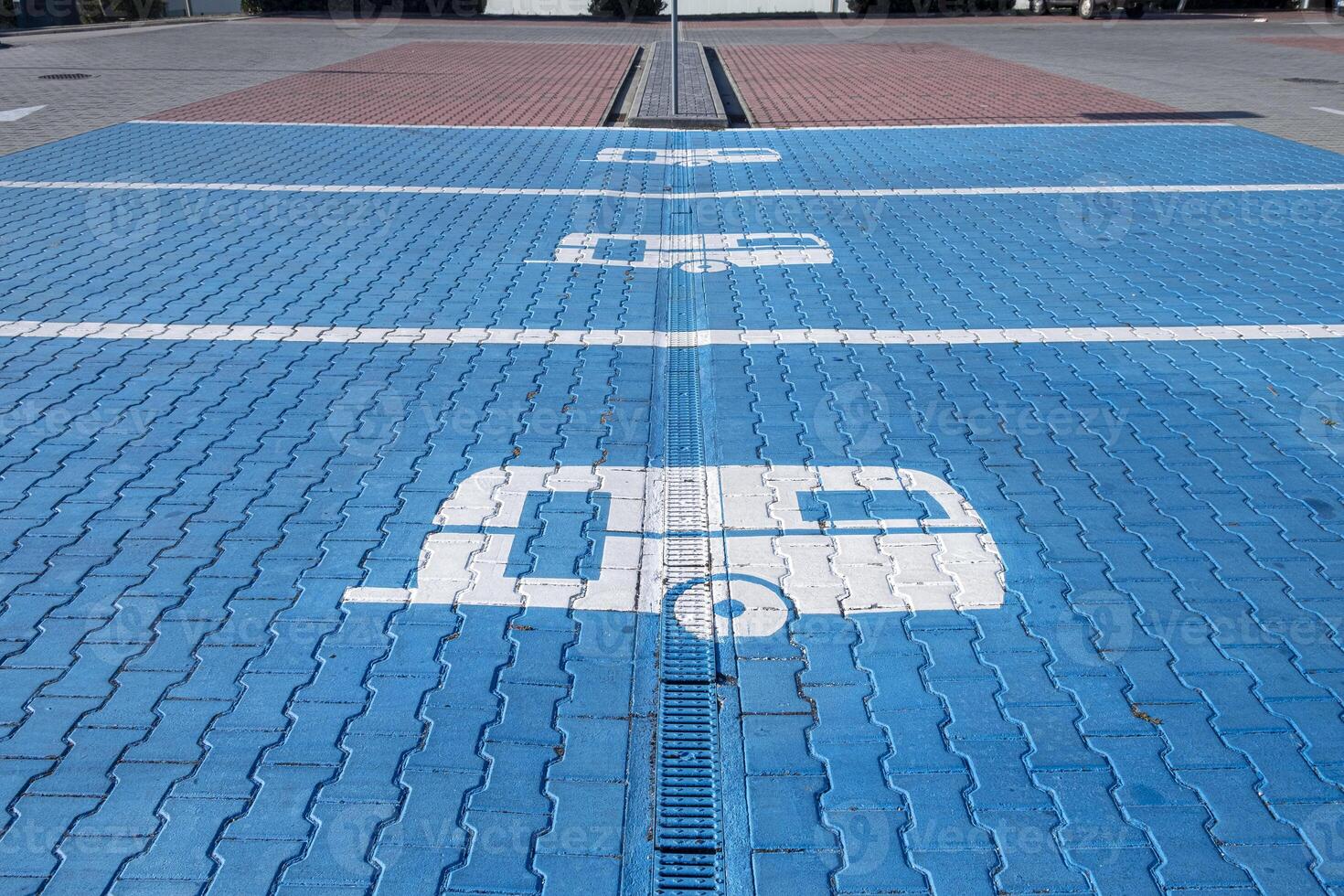 A blue parking lot with a white camper on it photo