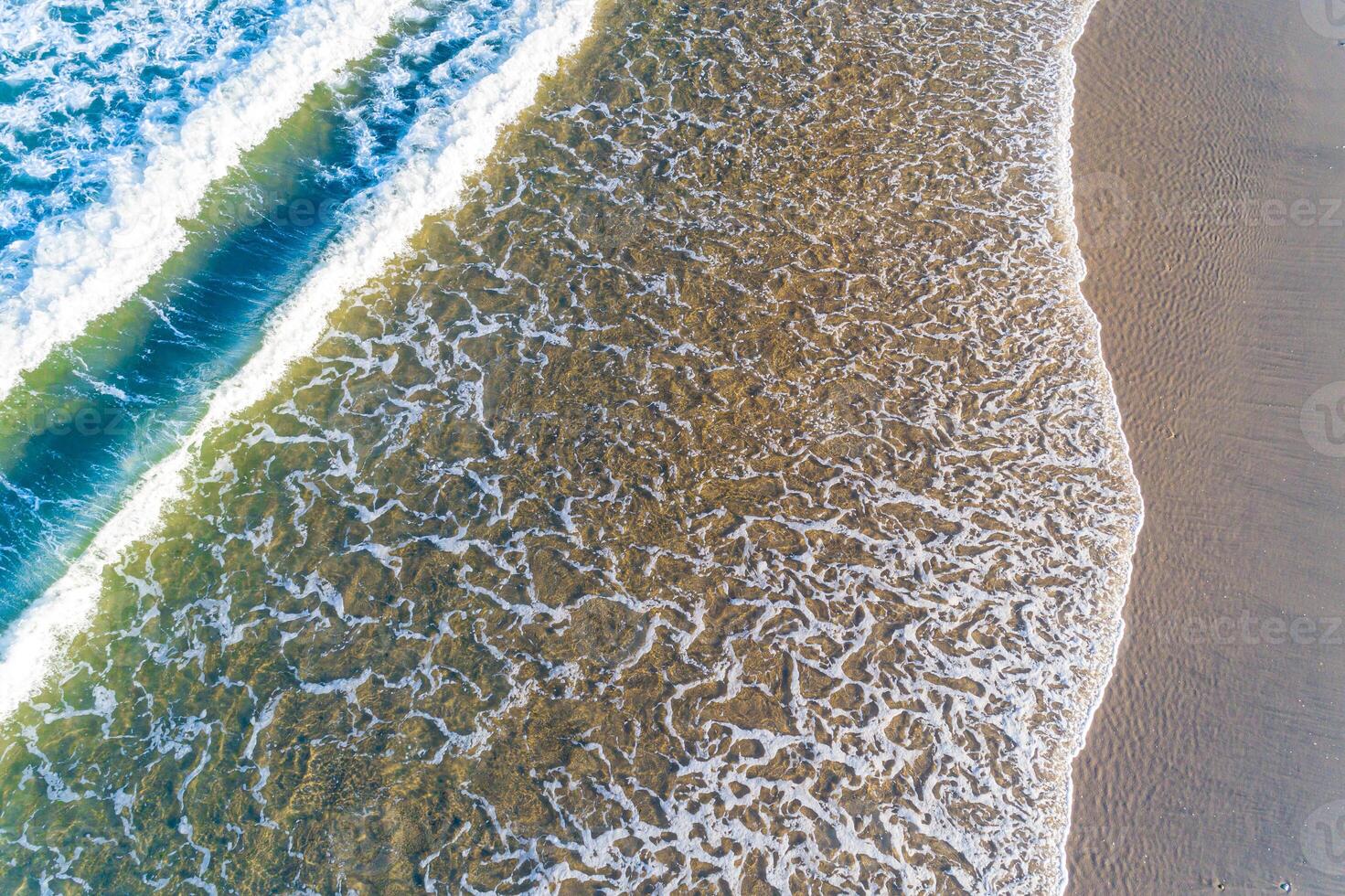 An aerial view of the ocean and waves photo