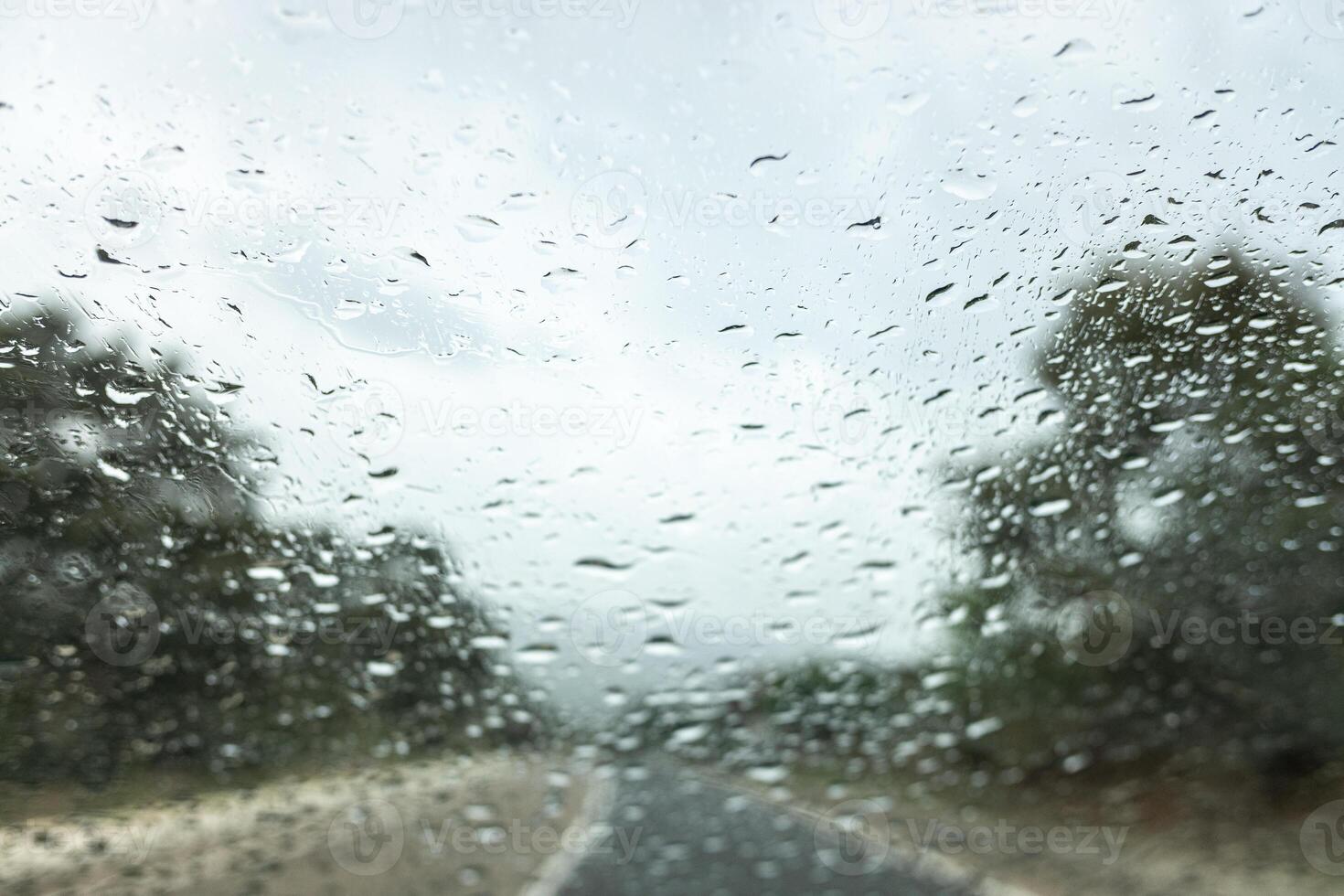 selective focus of raindrops on the windshield of a car in an autumn storm photo