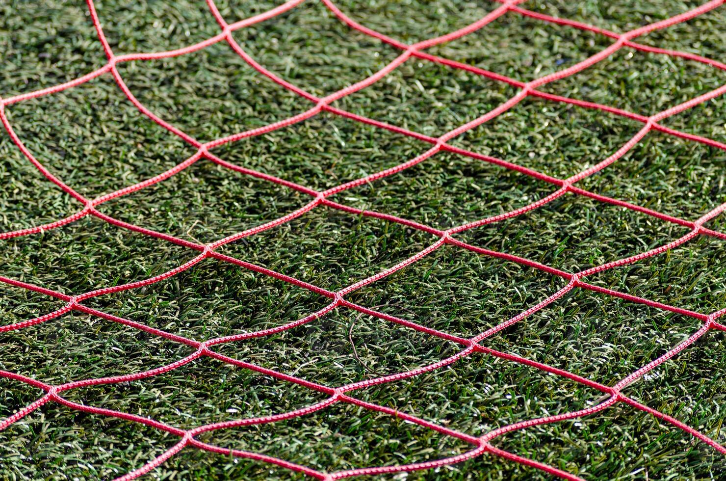 red netting of a football goal of an artificial grass football field photo