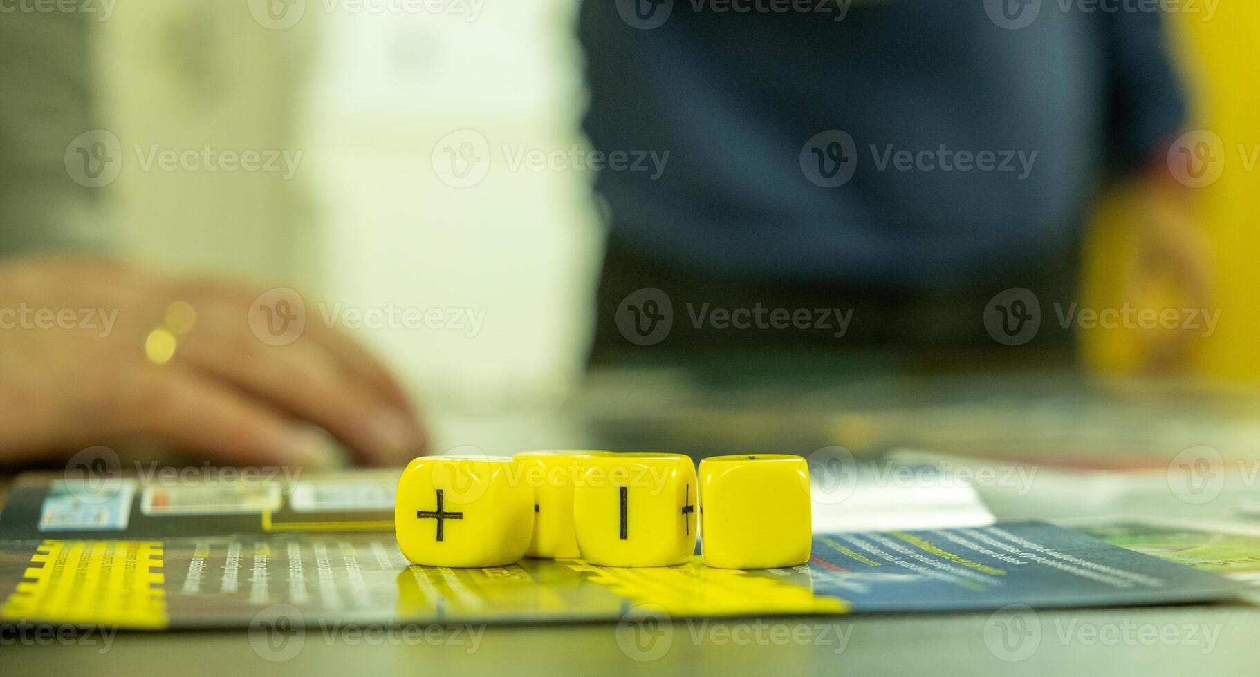 Role-playing instructions with four yellow six sided dices on top photo