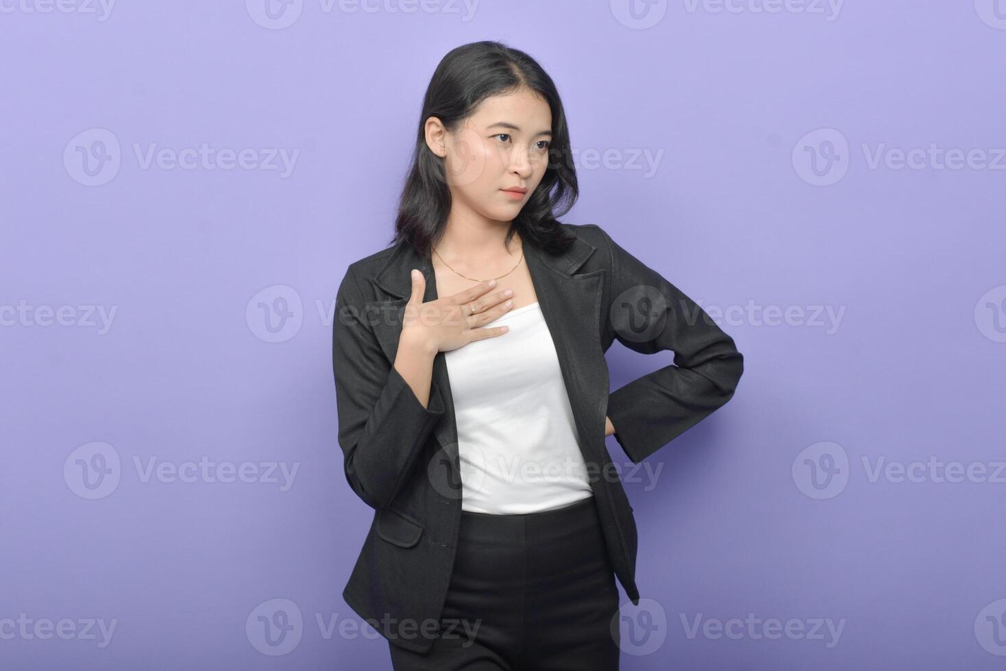 Asian business woman posing against purple background photo