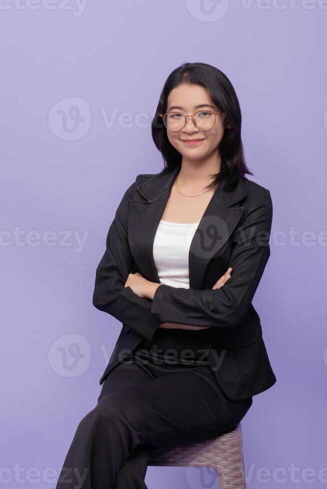 A woman in a business suit sitting on a chair photo
