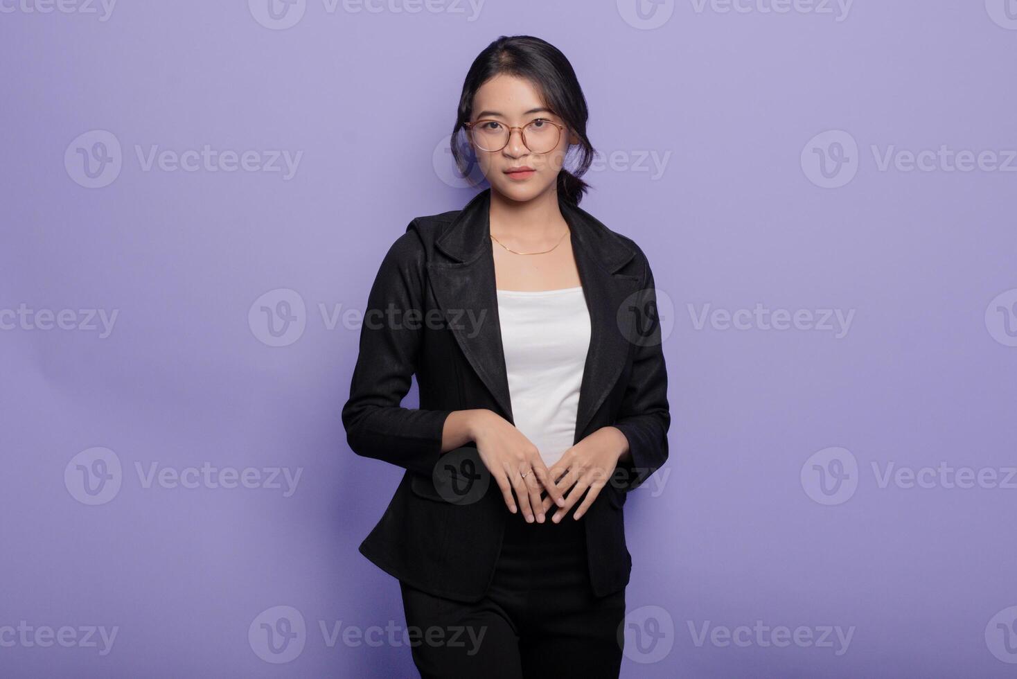 Asian business woman in black suit and white shirt standing on purple background photo