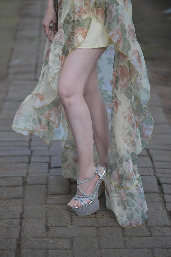 A woman wearing a dress and high heels photo
