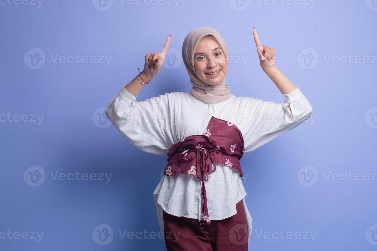 Young muslim woman with hijab over blue background photo