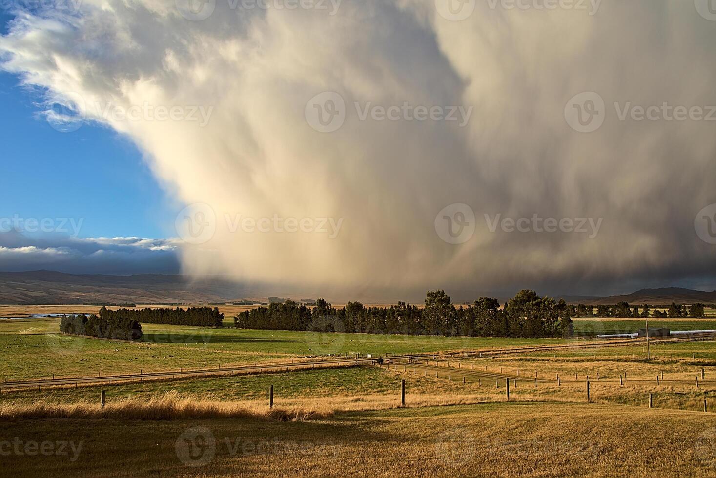A large storm clouds over a field photo