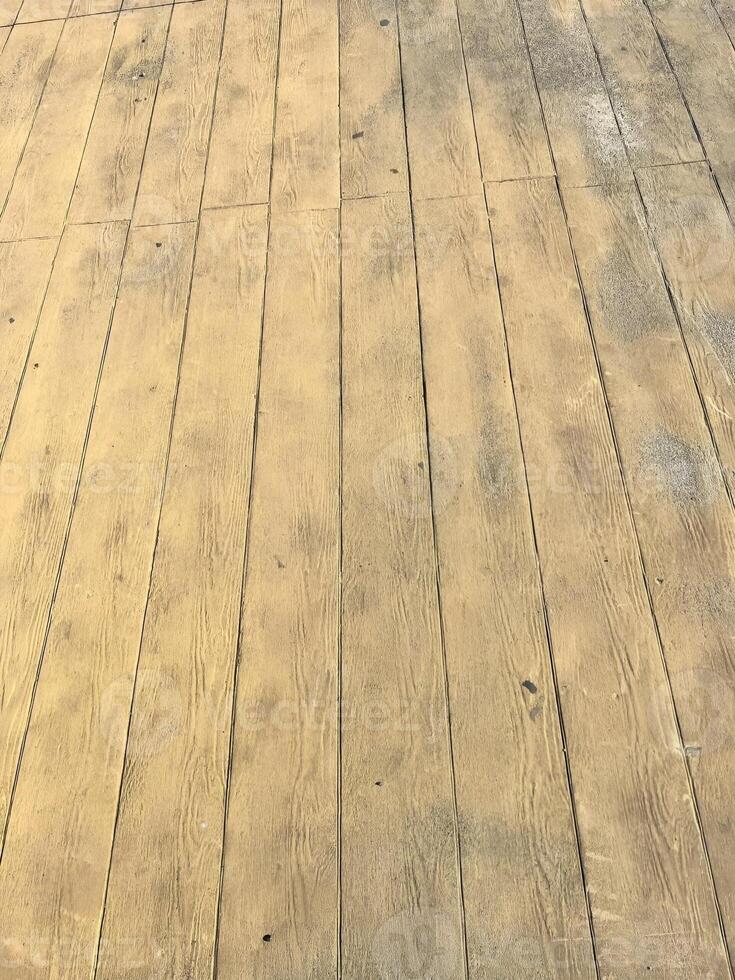 Wooden plank floor with natural texture and subtle weathered appearance in a rustic outdoor setting photo