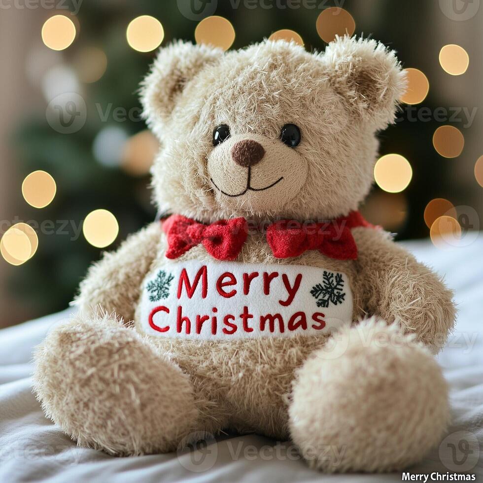 Fluffy teddy bear with a red bow and Merry Christmas message sitting in front of blurred holiday lights photo