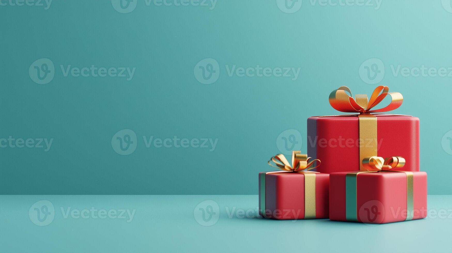 Red gift boxes with golden bows with copy space for text on a teal background representing festive Christmas holiday decor photo