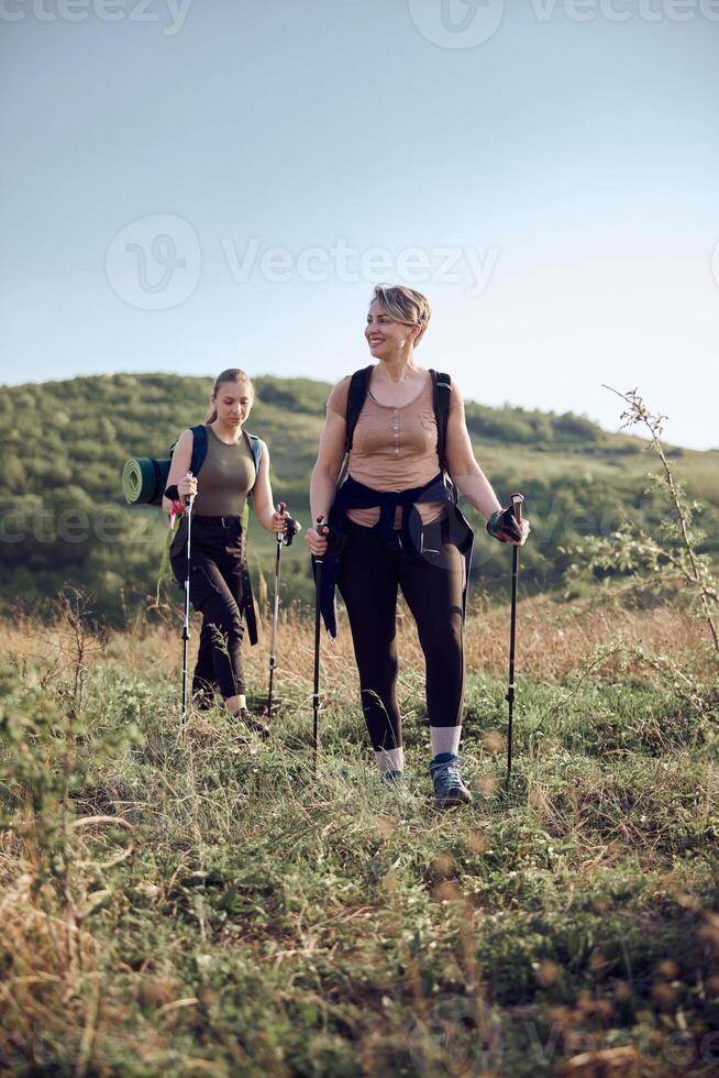 Two Women Hiking On Mountain photo