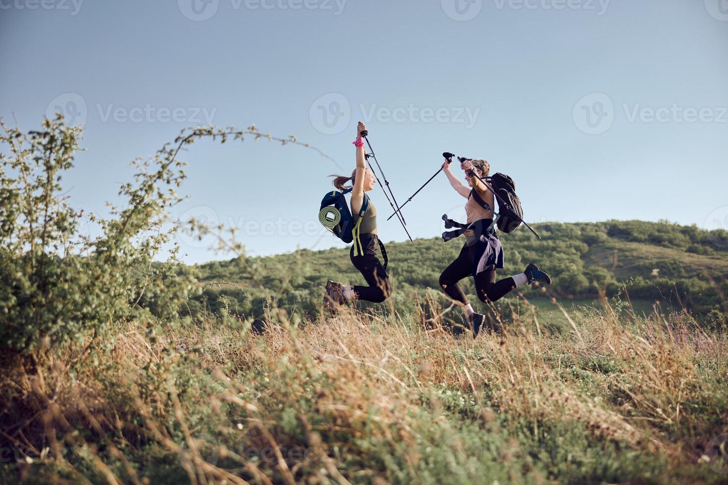 Two Women Celebrating After Getting On Top Of The Mountain photo