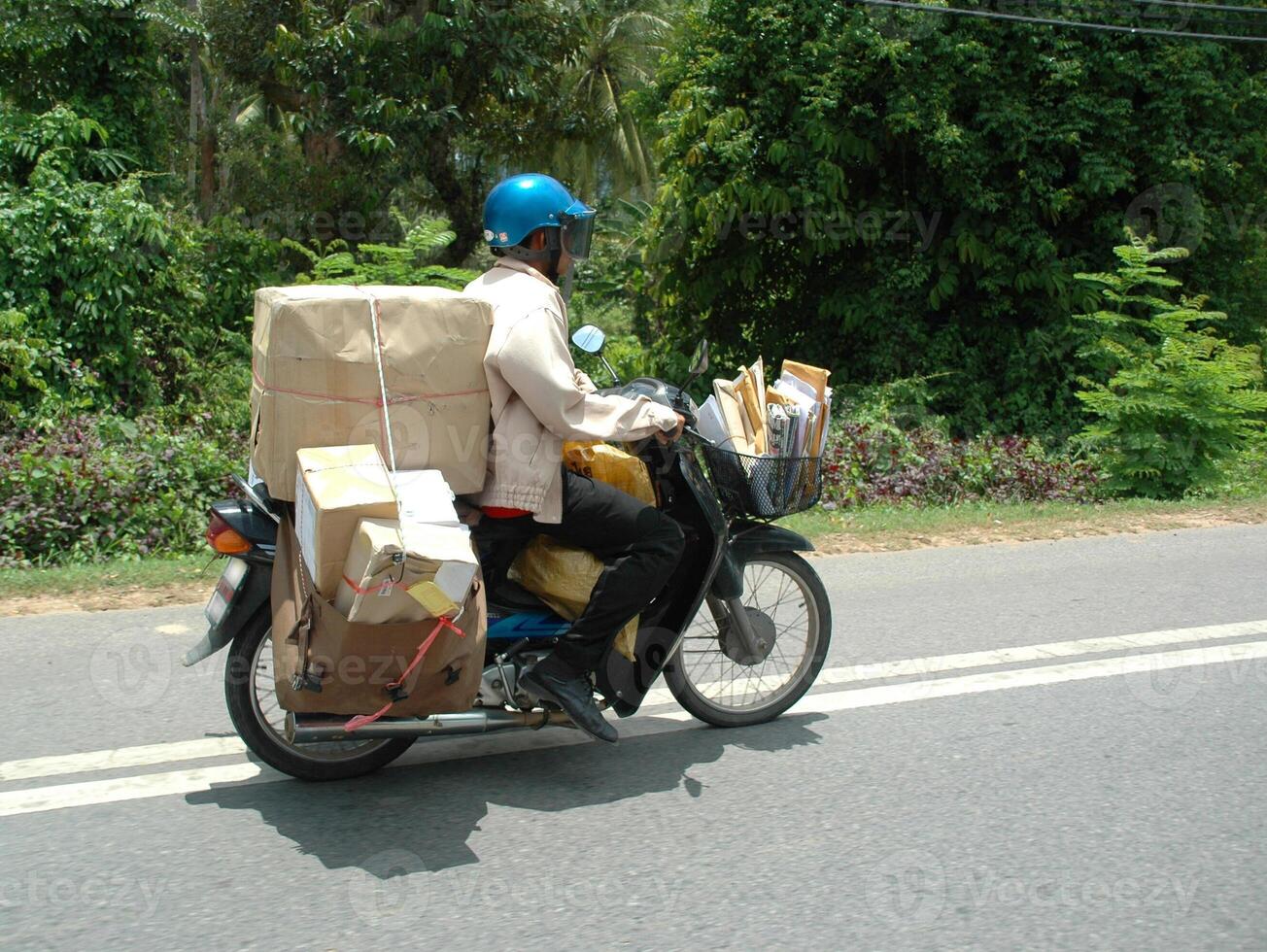 Postman on his bike photo