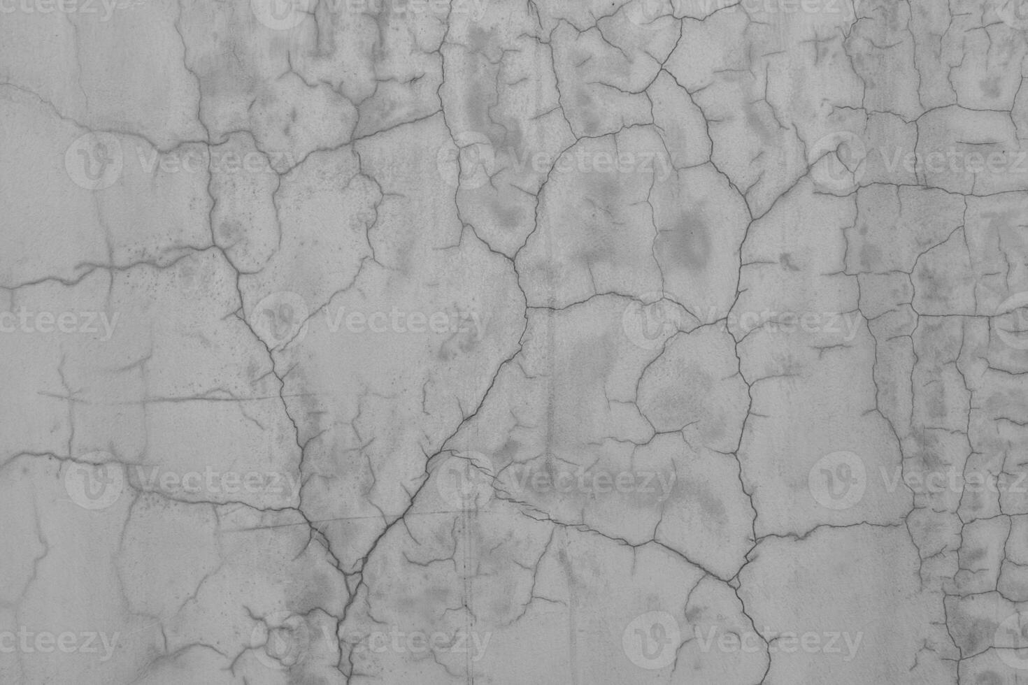 Cracks on the white plaster wall. Abstract design background. photo