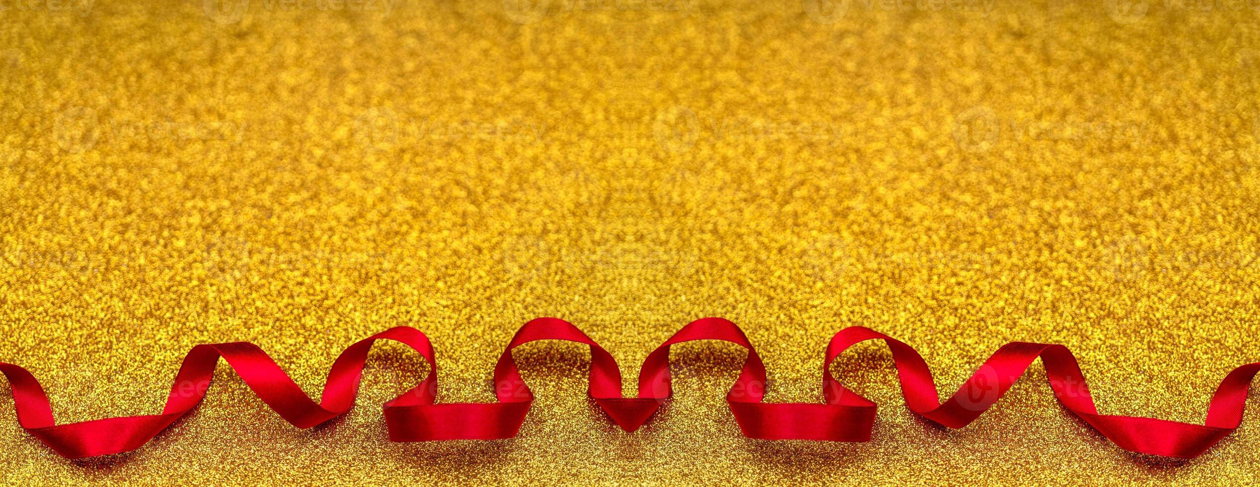 Red wavy ribbon on gold background. Holiday decoration. Valentine's Day decoration congratulation frame. photo